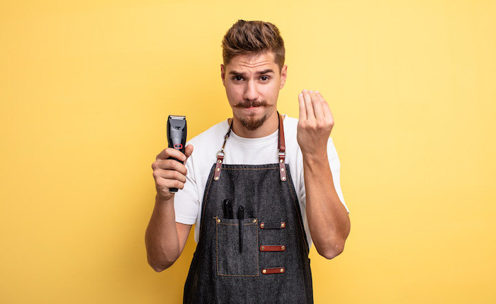 Barber With Mustache Holding Trimmer