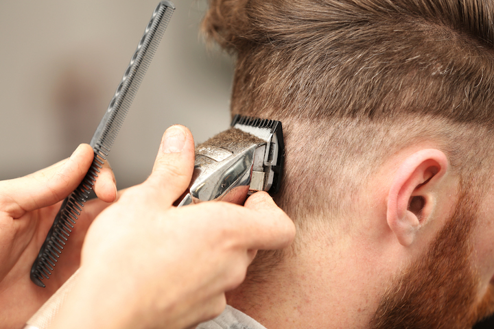 Barber Making a Fade Using Electric Clippers and Comb
