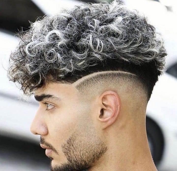 Curved And Platinum Highlighted Topshort curly undercut male
under cut curly hair
undercut with curls
