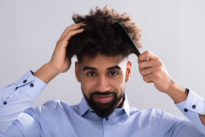Young Black Guy Combing His Hair Up