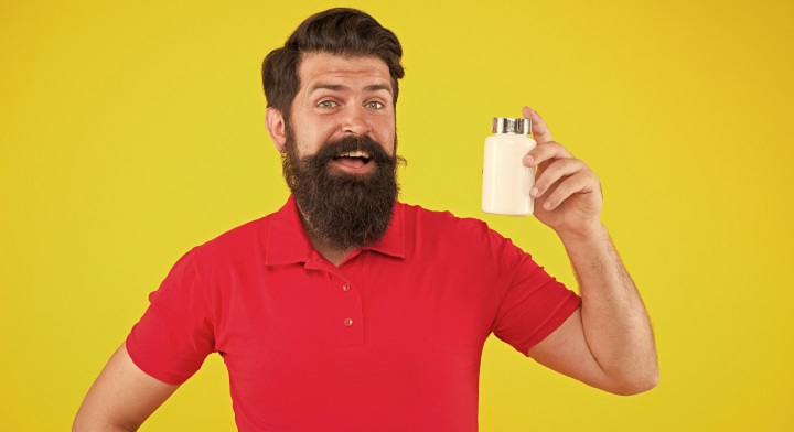 Bearded Man Holding Beard Care Product