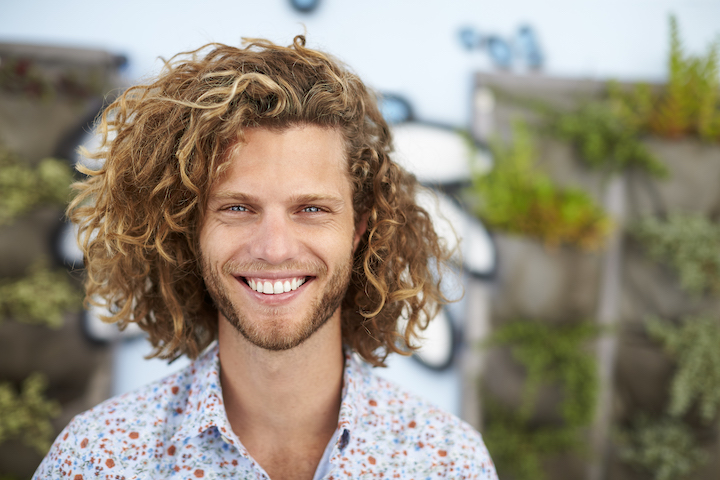 Blonde Guy With Curly Hair and Short Beard Smiling