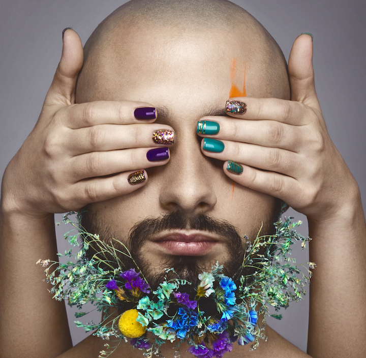 Bald Man With Flowers in Beard and Colorful Nails
