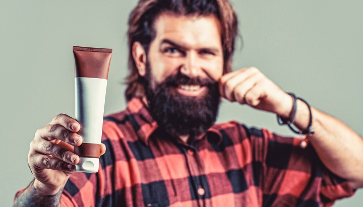 Smiling Bearded Man Holding a Tube