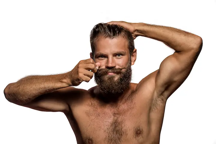 Enthusiastic Guy Styling His Full Beard and Mustache