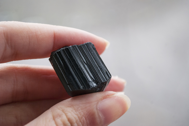 Holding Small Obsidian Stone