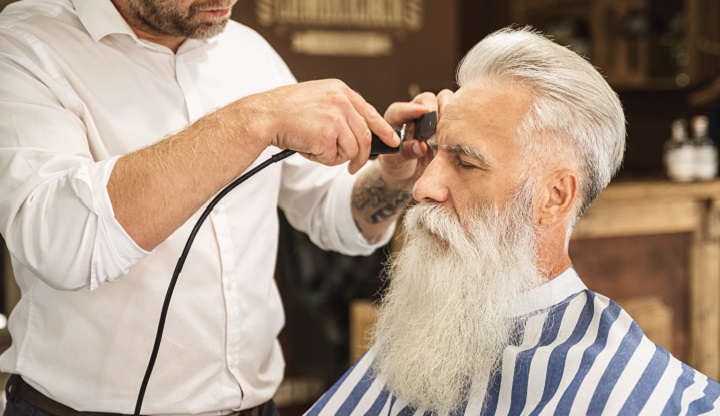 Man With Long White Beard Getting His Hair Trimmed