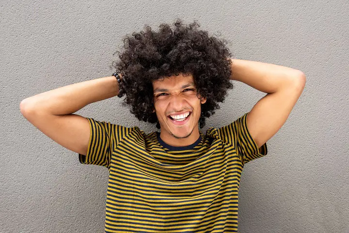 Portrait of Happy Young Man With Curly Hair