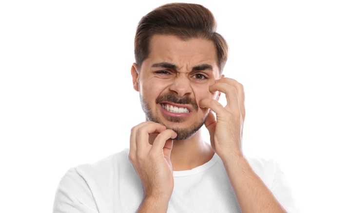 Man Scratching His Face and Beard