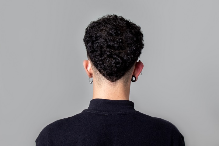 Young Man from Back With Curly Taper Fade Haircut