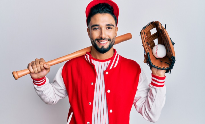 Bearded Baseball Player Holding a Ball and a Bat
