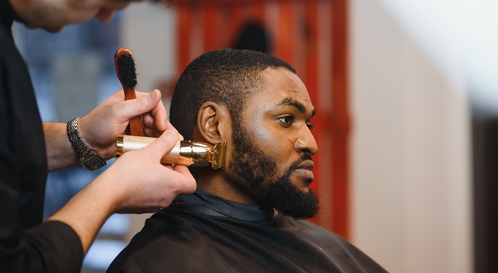 Barber Trimming Black Man's Beard