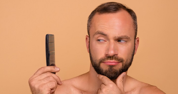 Bearded Man Looking at the Plastic Comb