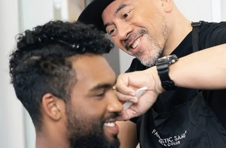 Smiling Barber Cutting Man's Hair