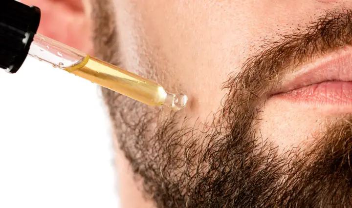 Applying Oil on a Beard With a Pipette