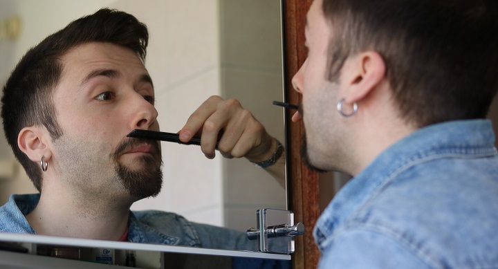 Man Combs His Mustache