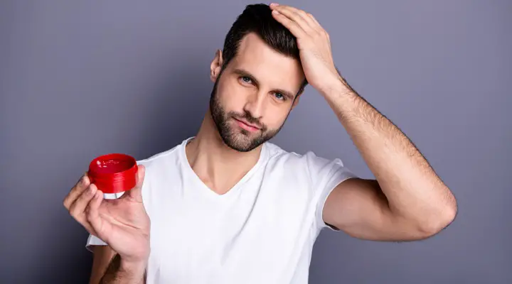 Man Putting Wax On Hair