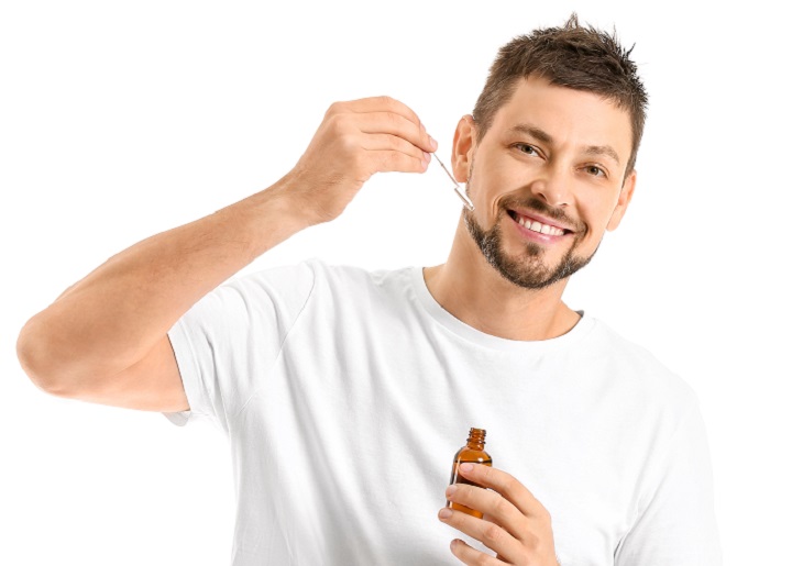 Men Putting Oil On His Beard