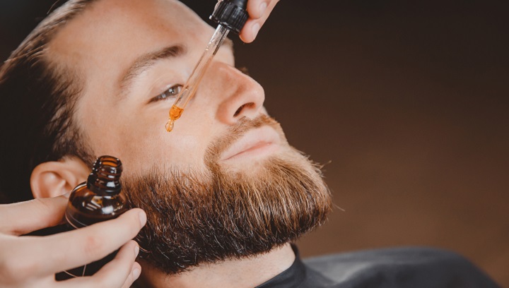 Putting Oil On Beard With a Pipette