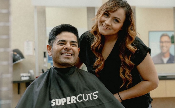 Smiling Lady Barber With a Client in Supercuts Salon