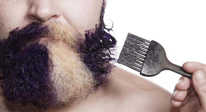 Applying Black Dye on Man's White Beard With a Brush