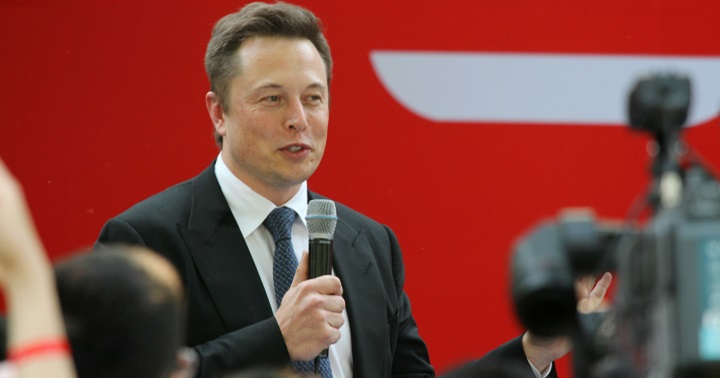 Elon Musk Holding a Microphone