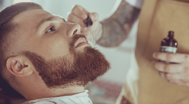 Applying Beard Oil to Bearded Man's Facial Hair