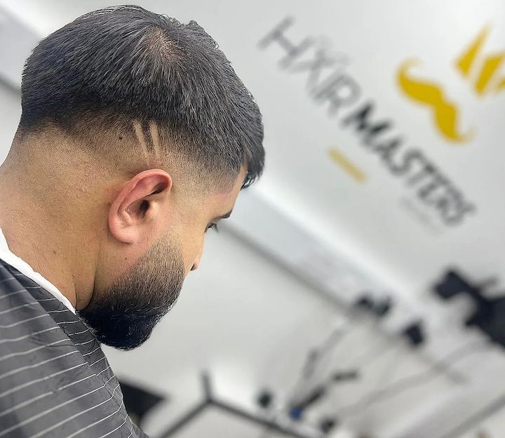 Man Getting His Haircut Done in Hairmasters Hair Salon