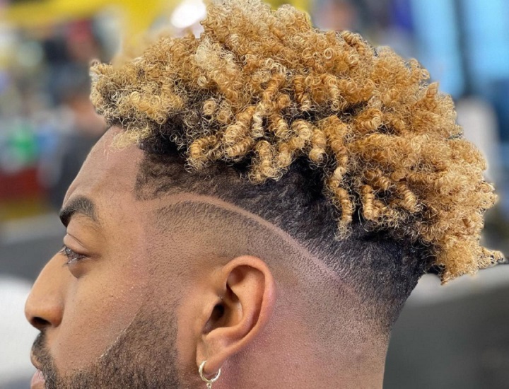 Man With a Bleached Curly Hard Part Hairstyle