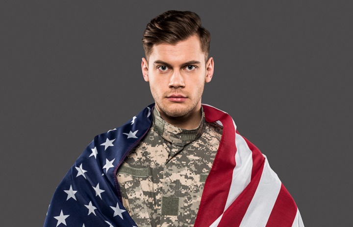 Man With Military Hairstyle in a Uniform With US Flag
