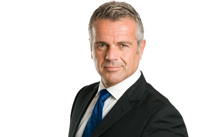 Older Man With a Professional Hairstyle in a Black Suit With Blue Tie