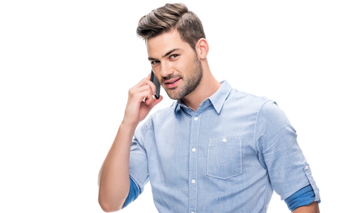 Young Man With Stubble Beard and an Undercut Hairstyle Talking on the Phone