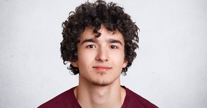 Teenager With Curly Hair and Soul Patch Beard