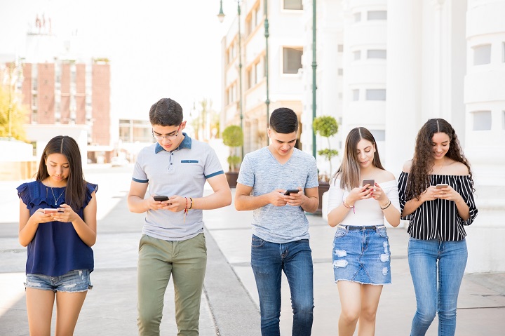 Young Boys and Girls Looking at Their Phones