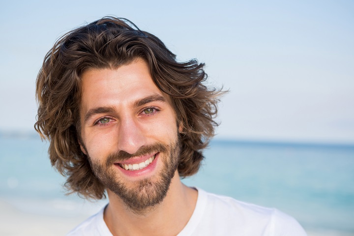 Smiling Bearded Man With a Messy Wavy Hair