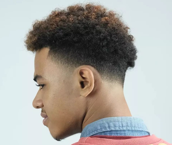 Black Man With a Curly Tape Up Hairstyle