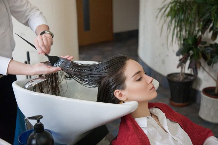 Dyeing Woman's Wet Hair in a Hair Salon