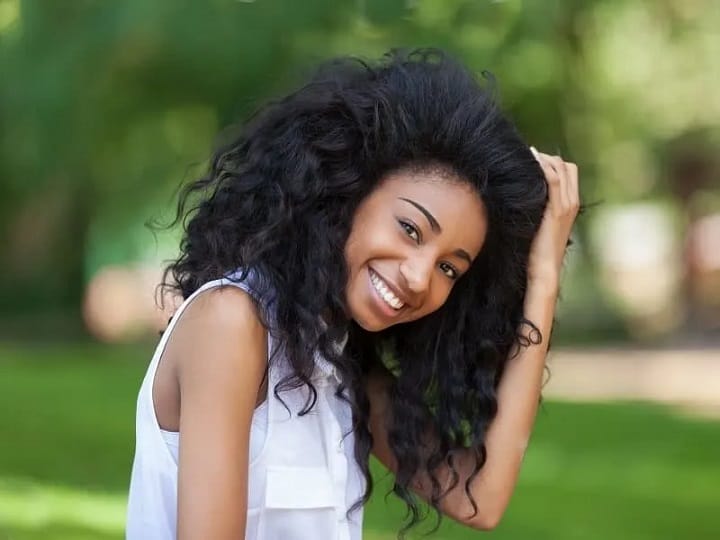 Smiling Young Girl With a Big Black Wavy Hair