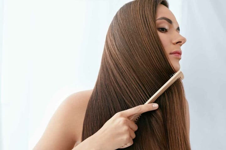 Girl Combing Her Long Brown Hair