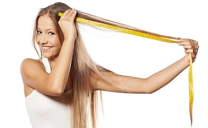 Girl Measuring Her Long Blonde Hair With a Meter
