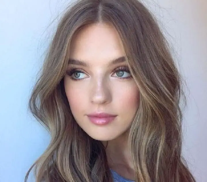 Girl With Ash Brown Face Framing Hairstyle