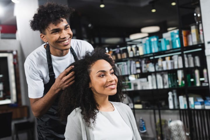 Male Hairstylist Styling Woman's Curly Hair