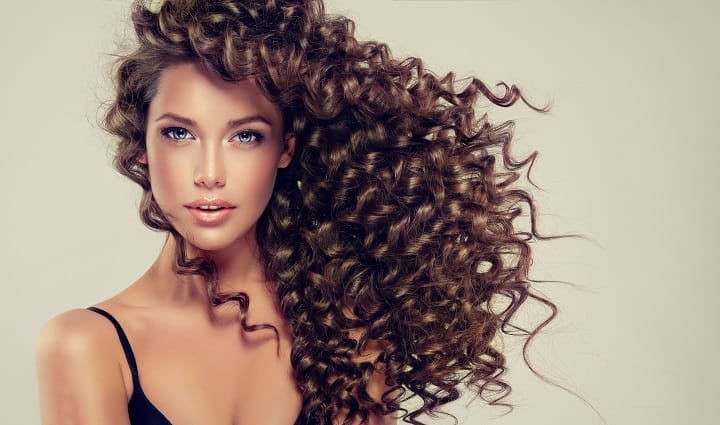 Young Woman With a Side Swept Long Curly Hair