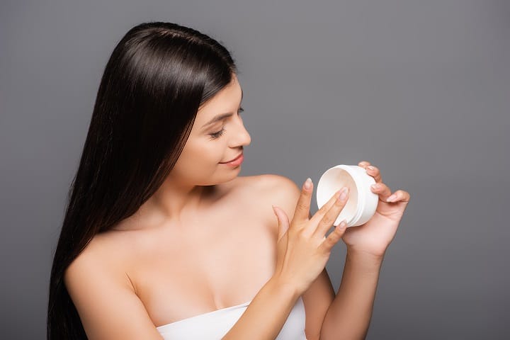 Brunette Woman Applying Hair Mask With Fingers