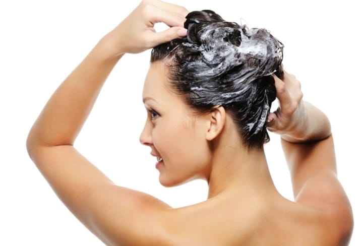 Woman Applying the Shampoo to Her Hair