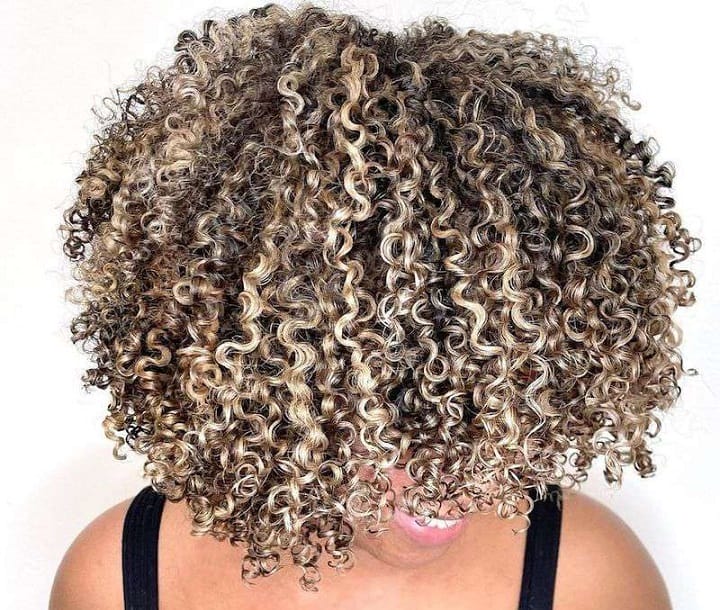 curly brown hair with blonde tips