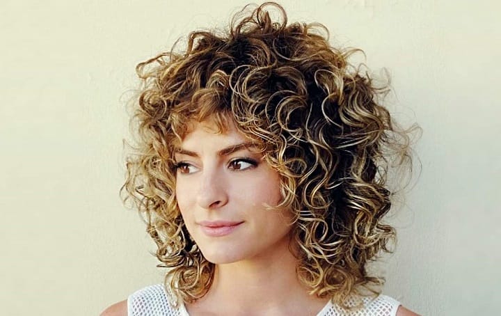 Woman With Shaggy Curly Bronde Bob Haircut