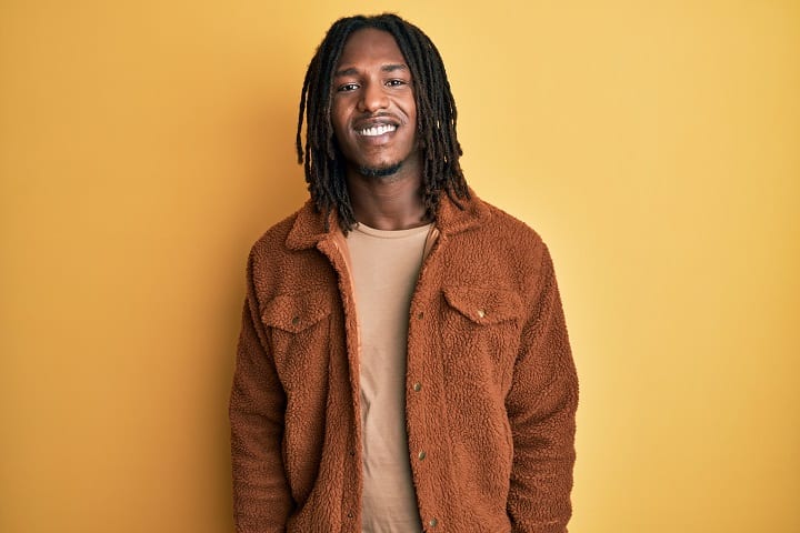 African Man With Braids Wearing Brown Jacket