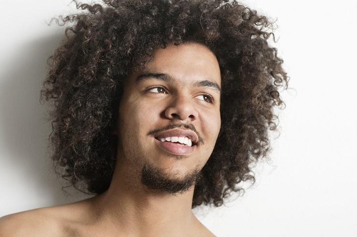 Close-up of a Happy Guy With Curly Hair