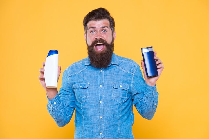 Man Holding Shampoo and Conditioner